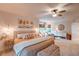 Bright main bedroom featuring a bed, sitting area, and natural light from the windows at 8229 Cottongrass Ct, Castle Pines, CO 80108
