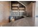 Basement wet bar with cabinetry, undercounter refrigerator, sink and shelving at 444 Glen Eagle Loop, Breckenridge, CO 80424