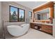 Elegant bathroom with a freestanding tub, modern vanity, and serene views at 444 Glen Eagle Loop, Breckenridge, CO 80424
