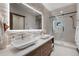 Elegant bathroom featuring dual sinks, a large mirror, and a glass-enclosed shower, offering a spa-like experience at 444 Glen Eagle Loop, Breckenridge, CO 80424