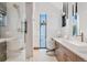 Modern bathroom with glass shower, vanity, and window overlooking a snowy scene at 444 Glen Eagle Loop, Breckenridge, CO 80424