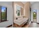 Bathroom featuring double sinks, modern vanity, and views of the outside at 444 Glen Eagle Loop, Breckenridge, CO 80424