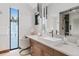 Modern bathroom with vanity, large mirror, and view of the snow-covered landscape at 444 Glen Eagle Loop, Breckenridge, CO 80424