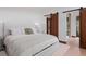 Serene bedroom features a comfortable bed, wood floors, and sliding doors offering ensuite bathroom access at 444 Glen Eagle Loop, Breckenridge, CO 80424