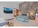 Beautiful bedroom with modern decor, mounted TV, and a view into the bathroom at 444 Glen Eagle Loop, Breckenridge, CO 80424