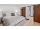 This bedroom features modern decor, a sliding closet door, and an ensuite bathroom at 444 Glen Eagle Loop, Breckenridge, CO 80424