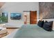 Stylish bedroom with TV, sliding barn door to bathroom, and modern decor at 444 Glen Eagle Loop, Breckenridge, CO 80424