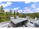 Deck featuring outdoor seating with mountain and forest views at 444 Glen Eagle Loop, Breckenridge, CO 80424
