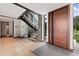 Grand foyer featuring wood floors, staircase and an impressive solid wood front door at 444 Glen Eagle Loop, Breckenridge, CO 80424