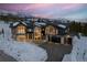 Stunning exterior view of mountain home with snow-covered landscape and attached garage at 444 Glen Eagle Loop, Breckenridge, CO 80424
