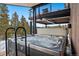Hot tub on a deck with metal railings surrounded by beautiful snowy mountain views at 444 Glen Eagle Loop, Breckenridge, CO 80424