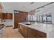 Modern kitchen featuring a large island, white countertops, and walnut cabinetry at 444 Glen Eagle Loop, Breckenridge, CO 80424