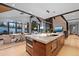 Open-concept kitchen and dining area with sleek appliances, marble island, and modern lighting at 444 Glen Eagle Loop, Breckenridge, CO 80424