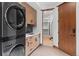 A practical laundry room with modern washer and dryer, ample cabinets, and a sink at 444 Glen Eagle Loop, Breckenridge, CO 80424