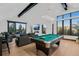 Bright living room with vaulted ceilings, large windows, and a pool table at 444 Glen Eagle Loop, Breckenridge, CO 80424