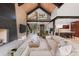 Expansive living area featuring sleek furnishings, fireplace, and scenic views at 444 Glen Eagle Loop, Breckenridge, CO 80424