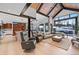 Open-concept living room with kitchen, vaulted ceilings, and large windows overlooking snowy landscape at 444 Glen Eagle Loop, Breckenridge, CO 80424