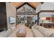 Open living room with staircase, kitchen, and entertainment center, accented by high ceilings at 444 Glen Eagle Loop, Breckenridge, CO 80424