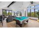 Large living room featuring a pool table, comfortable seating, vaulted ceilings, and scenic views at 444 Glen Eagle Loop, Breckenridge, CO 80424