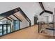 Open loft area with exposed beams, wood floors, and glass railings, offering a modern and airy feel at 444 Glen Eagle Loop, Breckenridge, CO 80424