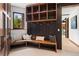 Inviting mudroom with custom built-in shelving, bench, and hooks by the entry at 444 Glen Eagle Loop, Breckenridge, CO 80424