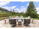 Backyard patio featuring a fire pit, comfortable seating, and lush landscaping with mountain views at 444 Glen Eagle Loop, Breckenridge, CO 80424
