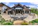 Backyard patio with a seating area around a fire pit and built-in BBQ grill, perfect for entertaining at 444 Glen Eagle Loop, Breckenridge, CO 80424