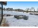 Snowy patio featuring an outdoor kitchen, grill, and covered outdoor furniture at 444 Glen Eagle Loop, Breckenridge, CO 80424