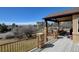 Enjoy outdoor living on this back porch with stone columns, a built-in grill, and peaceful neighborhood views at 5329 Pinyon Jay Rd, Parker, CO 80134