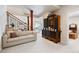 Finished basement with a cozy seating area, display cabinet, and staircase to the upper level at 5329 Pinyon Jay Rd, Parker, CO 80134