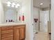 Bright bathroom with a large mirror, tiled countertop, and a separate toilet area for added privacy at 5329 Pinyon Jay Rd, Parker, CO 80134