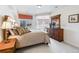 Spacious bedroom with large windows, bay window, plush carpeting, and a dark wood dresser at 5329 Pinyon Jay Rd, Parker, CO 80134