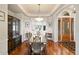 Elegant dining room boasting hardwood floors, recessed lighting, and large windows for ample natural light at 5329 Pinyon Jay Rd, Parker, CO 80134