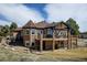 A two-story home features a stone turret, large windows and a covered deck perfect for outdoor enjoyment at 5329 Pinyon Jay Rd, Parker, CO 80134