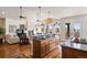 Open concept kitchen with granite countertops, island, and seamless flow into the living area at 5329 Pinyon Jay Rd, Parker, CO 80134