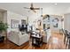 Bright living room with vaulted ceilings, a fireplace, comfortable seating, and natural light streaming through large windows at 5329 Pinyon Jay Rd, Parker, CO 80134