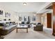 Comfortable living room with plush seating, french doors and neutral decor at 5329 Pinyon Jay Rd, Parker, CO 80134
