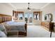 Tranquil main bedroom featuring a tray ceiling, ceiling fan, and private balcony access at 5329 Pinyon Jay Rd, Parker, CO 80134