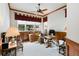 Well-appointed home office with wood paneling, ceiling fan, and ample natural light at 5329 Pinyon Jay Rd, Parker, CO 80134