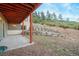 Covered patio with a stone retaining wall and wood fence at 4840 Limestone Rd, Monument, CO 80132