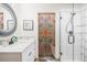 Clean bathroom with a modern vanity, a glass shower, and a bamboo curtain at 4840 Limestone Rd, Monument, CO 80132