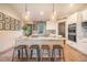 Modern kitchen with granite island, stainless steel appliances, and farmhouse-style sink at 4840 Limestone Rd, Monument, CO 80132