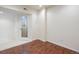 Basement space with vinyl floors, a unique wine cellar door, and neutral paint at 7370 S Catawba Way, Aurora, CO 80016
