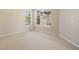 Bright bedroom with large windows, carpeted floors, and neutral walls providing a serene living space at 7370 S Catawba Way, Aurora, CO 80016