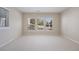 Spacious bedroom with carpeted floors and three windows providing abundant natural light at 7370 S Catawba Way, Aurora, CO 80016