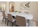 Elegant dining area with seating for six, complemented by stylish decor and abundant natural light, perfect for gatherings at 7370 S Catawba Way, Aurora, CO 80016