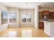 Bright dining area features hardwood floors, natural light from the surrounding windows, and a decorative chandelier at 7370 S Catawba Way, Aurora, CO 80016