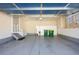 Spacious garage featuring ample storage cabinets, painted floors, and a functional workspace, offering practical utility and organization at 7370 S Catawba Way, Aurora, CO 80016