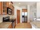 Bright kitchen features stainless steel appliances, granite countertops, hardwood floors, and wood cabinets at 7370 S Catawba Way, Aurora, CO 80016