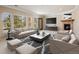 Bright and airy living room boasts a cozy fireplace and large windows, complete with a TV, and stylish furnishings at 7370 S Catawba Way, Aurora, CO 80016